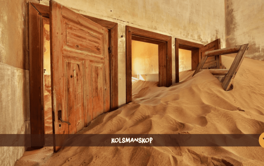 A room with three doors in Kolmanskop with a sand dune inside of it