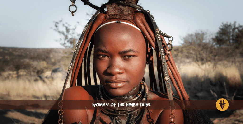 A Himba woman with ochre-red strands of hair and necklaces